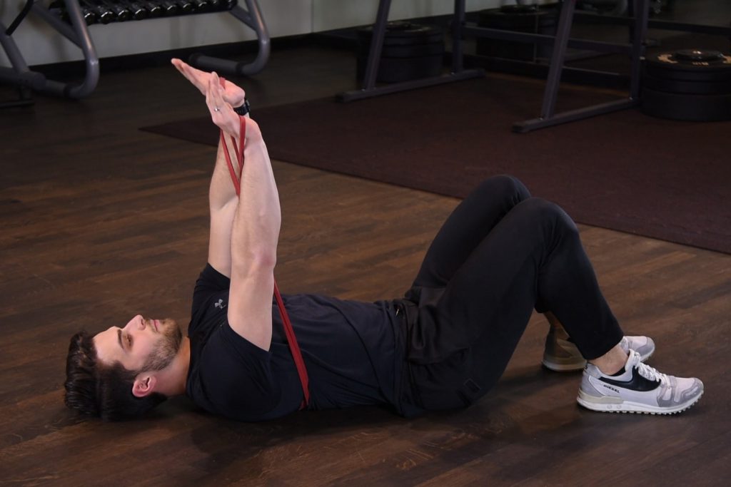 Wyciskanie gumy power band leżąc na ziemi